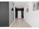 Hallway with neutral tile flooring, decorative mirrors and artwork, and dark grey accent walls at 429 Ohio Way, Kissimmee, FL 34759