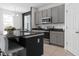 Modern kitchen featuring granite countertops, stainless steel appliances, and a breakfast bar with seating at 429 Ohio Way, Kissimmee, FL 34759