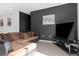 Spacious living room featuring a large sectional sofa, TV, and modern decor at 429 Ohio Way, Kissimmee, FL 34759