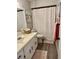 Bathroom with modern fixtures, white vanity, framed mirror, and shower with a curtain at 4565 Old Colony Rd, Mulberry, FL 33860