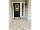 Inviting entryway with a decorative front door, exterior lighting, and paved walkway at 4565 Old Colony Rd, Mulberry, FL 33860