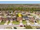 Aerial view of homes in a community with backyard lake views, mature trees and manicured lawns at 4605 Kalispell Rd, Kissimmee, FL 34758