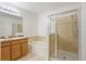 Bathroom with dual sinks, bathtub, and a glass shower enclosure at 4605 Kalispell Rd, Kissimmee, FL 34758