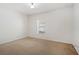 Neutral bedroom with carpeted floor and window that brings in natural light at 4605 Kalispell Rd, Kissimmee, FL 34758