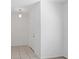 Bright entryway featuring neutral tile flooring, a white front door, and modern lighting fixture at 4605 Kalispell Rd, Kissimmee, FL 34758
