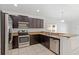 Well-equipped kitchen featuring stainless steel appliances, granite countertops, and dark wood cabinetry at 4605 Kalispell Rd, Kissimmee, FL 34758