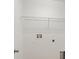 A closer view of the laundry room featuring connections and a wire rack shelf at 4605 Kalispell Rd, Kissimmee, FL 34758