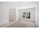 Bright, carpeted living room featuring white walls, tile entry and a window with natural light at 4605 Kalispell Rd, Kissimmee, FL 34758