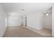 Open concept living area with neutral carpeting and tile, white walls and modern lighting at 4605 Kalispell Rd, Kissimmee, FL 34758