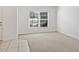 Bright living room featuring carpeted floors, white walls, and a window with natural light at 4605 Kalispell Rd, Kissimmee, FL 34758