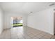 Open-concept living area with neutral walls and tile flooring at 4605 Kalispell Rd, Kissimmee, FL 34758