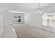 Spacious living area with neutral carpeting and tile, white walls and bright natural light at 4605 Kalispell Rd, Kissimmee, FL 34758