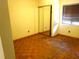 A bedroom with parquet flooring, mirrored closet doors, neutral walls, and a window with blinds at 4790 Point Look Out Rd, Orlando, FL 32808