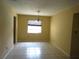 A brightly lit dining room features neutral walls, tile flooring, chandelier, and a window with blinds at 4790 Point Look Out Rd, Orlando, FL 32808