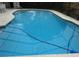 Refreshing in-ground pool with clear blue water and a screened enclosure for ultimate relaxation and privacy at 4790 Point Look Out Rd, Orlando, FL 32808