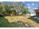 A spacious backyard with lush greenery, mature trees, and a wooden fence, perfect for outdoor enjoyment at 4900 Kempston Dr, Orlando, FL 32812