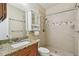 Bright bathroom with granite countertop vanity, built-in storage, and walk-in shower with neutral tile at 4900 Kempston Dr, Orlando, FL 32812