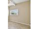 Cozy bedroom featuring neutral walls, a window with blinds, and light tile flooring at 4900 Kempston Dr, Orlando, FL 32812