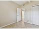 The bedroom features tile flooring, a closet, and neutral colored walls with natural light at 4900 Kempston Dr, Orlando, FL 32812