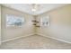 Bright bedroom featuring updated fan, dual windows with blinds, and tiled floors at 4900 Kempston Dr, Orlando, FL 32812