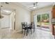 Dining area features tile flooring, a ceiling fan and a sliding door to backyard at 4900 Kempston Dr, Orlando, FL 32812