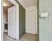 Home entryway featuring tile flooring, a secure front door, and easy access to laundry facilities at 4900 Kempston Dr, Orlando, FL 32812