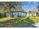 Landscaped front yard of home with vibrant greenery and healthy, mature trees at 4900 Kempston Dr, Orlando, FL 32812