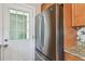 Stainless steel refrigerator and exterior door add modern convenience to this kitchen at 4900 Kempston Dr, Orlando, FL 32812