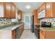Well-equipped kitchen features granite countertops, stainless steel appliances, and ample cabinet space at 4900 Kempston Dr, Orlando, FL 32812