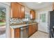 Updated kitchen featuring modern appliances, wood cabinetry and a backyard view at 4900 Kempston Dr, Orlando, FL 32812