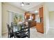 This kitchen and dining area features wooden cabinets and backsplash with sliding glass doors to the backyard at 4900 Kempston Dr, Orlando, FL 32812