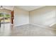Living room features neutral walls, tile flooring and sliding door access to backyard at 4900 Kempston Dr, Orlando, FL 32812