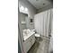 Functional bathroom features a single sink vanity and a shower with a patterned curtain at 5356 Oakbourne Ave, Davenport, FL 33837