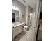 Cozy bathroom with a single sink vanity and glass-enclosed shower at 5356 Oakbourne Ave, Davenport, FL 33837