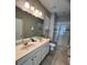 Bathroom featuring a double sink vanity and glass-enclosed shower at 5356 Oakbourne Ave, Davenport, FL 33837