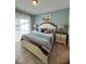 Comfortable bedroom with a decorative headboard, side tables, and calming decor at 5356 Oakbourne Ave, Davenport, FL 33837