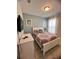 Comfortable bedroom with a queen bed, dresser, and bright natural light at 5356 Oakbourne Ave, Davenport, FL 33837