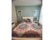 Inviting bedroom featuring a colorful patterned bedspread and decorative pillows at 5356 Oakbourne Ave, Davenport, FL 33837
