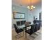 Elegant dining area with a modern glass table, seating for eight, and stylish decor at 5356 Oakbourne Ave, Davenport, FL 33837