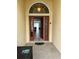 Welcoming entryway with a red door and views into the home's open-concept living spaces at 5356 Oakbourne Ave, Davenport, FL 33837