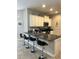 Well-equipped kitchen featuring granite countertops, bar seating, and stainless steel appliances at 5356 Oakbourne Ave, Davenport, FL 33837