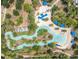 Aerial view of the community's lazy river with lush landscaping and shaded seating areas at 5356 Oakbourne Ave, Davenport, FL 33837