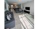Spacious living room featuring tile floors, comfortable sofas, and a modern aesthetic at 5356 Oakbourne Ave, Davenport, FL 33837