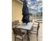 Outdoor patio with an umbrella-covered table and chairs with access to the community pool and spa at 5356 Oakbourne Ave, Davenport, FL 33837
