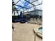 Outdoor patio area features a screened-in pool, spa, and comfortable lounge seating at 5356 Oakbourne Ave, Davenport, FL 33837