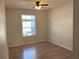 Bedroom featuring wood look flooring, large window, neutral colored walls and ceiling fan at 586 Brantley Terrace Way # 201, Altamonte Springs, FL 32714