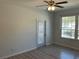 Bedroom featuring wood look flooring, large window, neutral colored walls and ceiling fan at 586 Brantley Terrace Way # 201, Altamonte Springs, FL 32714