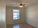 Bright bedroom with a ceiling fan, a window providing natural light, and laminate flooring throughout at 586 Brantley Terrace Way # 201, Altamonte Springs, FL 32714