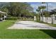 Outdoor volleyball court surrounded by lush green grass and mature trees, providing a recreational space at 586 Brantley Terrace Way # 201, Altamonte Springs, FL 32714
