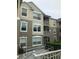 Three-story condo building with large windows, screened balconies, and accessible ramp surrounded by lush landscaping at 586 Brantley Terrace Way # 201, Altamonte Springs, FL 32714
